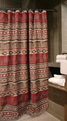 a bathroom with a shower curtain and towels