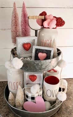 a metal bucket filled with valentine's day decorations and cards on top of a table