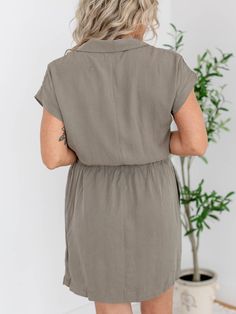 This utility-inspired shirt dress features a cinched waist for a flattering fit, perfect for any occasion. Embrace a cool and casual look while turning heads with this must-have addition to your wardrobe! Thread and Supply Cinched waistline Cargo pockets Button down silhouette 60% Tencel, 40% Rayon Body length measurement: 33" from a S. Bust measurement: 19.5" from a S. Model is wearing a S. Collared Rayon Dress For Day Out, Rayon Day Out Dress With Tie Waist, Relaxed Fit Rayon Dresses For Work, Relaxed Fit Rayon Dress For Work, Midi Length Rayon Shirt Dress For Day Out, Casual Collared Rayon Dress, Casual Midi Dress With Elastic Waistband For Fall, Casual Solid Shirt Dress For Daywear, Casual Midi Dress With Fitted Waist For Work