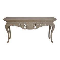 an ornate console table with carvings on the top and bottom, in whitewash wood