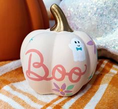 a painted pumpkin sitting on top of a table