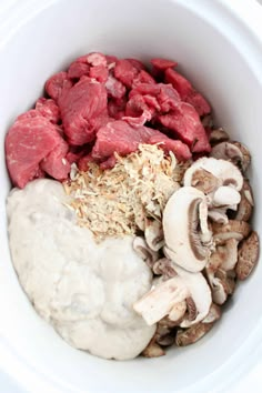 a white bowl filled with meat, mushrooms and other ingredients for a mushroom soup recipe