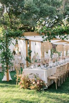 an image of a table set up with flowers and greenery for a wedding reception