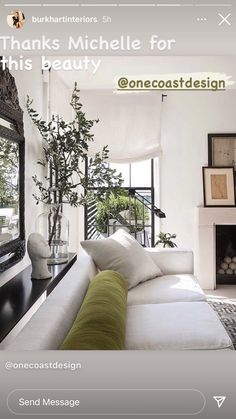 a living room filled with furniture and a large mirror on the wall next to a fire place