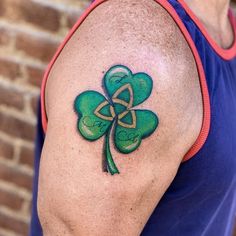 a man with a shamrock tattoo on his arm