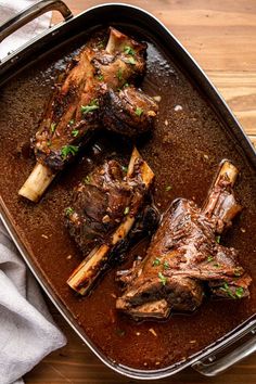 some meat in a pan on a wooden table