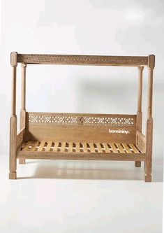 a wooden bed frame with an intricately carved design on the top and bottom sides