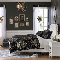 a bed room with a neatly made bed and a chandelier