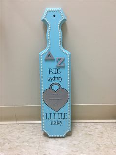 a blue bottle with the words big sydney and little italy on it sitting in front of a wall