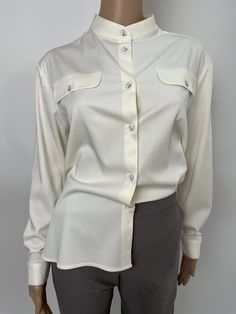 Elegant white viscose blouse, soft and pleasant to the body material. Loose silhouette with buttons down the front. Long sleeve with cuff. Button cuff fastening. The blouse is suitable for the office and for free time. Perfectly combined with a skirt, trousers and jeans. We also make the model in individual sizes. If you wish, send your measurements and you will have a blouse just for you. We make quality garments for sustainable fashion. We do not accept returns or exchanges for this product if White Shirt For Women, Skirt Trousers, Viscose Blouse, Jumpsuit Fitted, Collarless Shirt, Elegant Shirt, Shirt Long Sleeve, Shirt For Women, Shirt Fashion