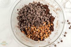 a bowl filled with chocolate chips and nuts