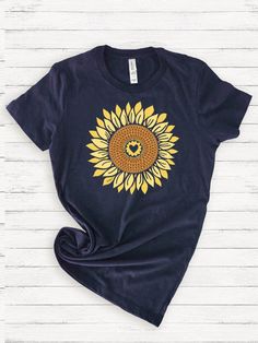 Big happy sunflowers that bloom all year long! * Solid colors are 100% Airlume combed and ring-spun cotton * Heather colors are a cotton/poly blend * Heather colors are 52% combed and ring-spun cotton, 48% polyester; Athletic Heather is 90% combed and ring-spun cotton, 10% polyester; Heather Prism colors are 99% combed and ring-spun cotton, 1% polyester * Fabric weight: 4.2 oz./yd.² (142 g/m²) * Pre-shrunk mid-weight fabric * Side-seamed construction * Shoulder-to-shoulder taping * Tear-away lab Hand Drawn Sunflower, Drawn Sunflower, Prism Color, My Heart, Unisex T Shirt, Fabric Weights, Favorite Outfit, Spun Cotton, Sunflower