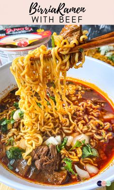 a bowl of beef ramen with beef and noodles is being held up by chopsticks