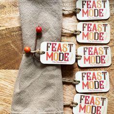 four tags with the words feast mode on them are attached to a piece of cloth