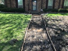 an old train track is in front of a house