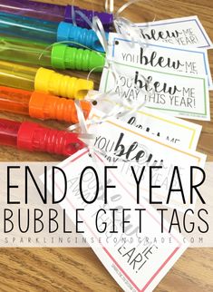 the end of year bubble gift tags are shown with markers on them and tied together