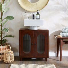 a white sink sitting next to a wooden cabinet