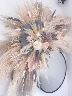 a headband with flowers and feathers on it sitting on top of a white table