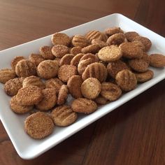 a white plate topped with cookies on top of a wooden table