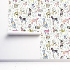 a wallpaper with dogs and flowers on it in an empty room next to a white wall