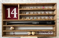 a wooden shelf with baseballs, bats and numbers on it