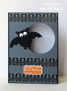 a black and white halloween card with a bat in the hole on it's side