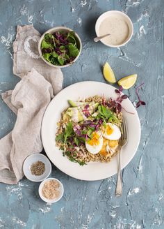 an image of a plate of food with eggs and greens on the side next to it