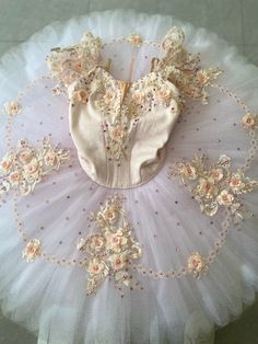 a pink and white tutu with flowers on it