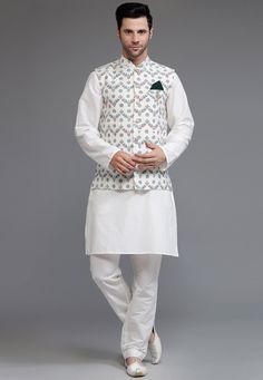 Cotton Silk Kurta with a Cotton Silk Pant in Off White Color. Available with a Cotton Silk Nehru Jacket in Off White color. This Chinese Collar Neck and Half Sleeve Ready-made attire is Enhanced with Buttons and Digital Print.   Do note: Brooch and Footwear shown in the image is for presentation purposes only. Half to one inch may vary in measurement. (Slight variation in actual color vs. image is possible) We Sell all kinds of Menswear. Mens Kurta | Mens Kurta & Pant | Traditional Menswear | Ge Traditional White Sets For Workwear, White Kurta For Workwear And Eid, White Kurta For Eid Workwear, Traditional White Sets With Stand Collar, White Fitted Kurta With Stand Collar, White Nehru Jacket With Stand Collar For Festive Occasions, White Bandhgala With Stand Collar For Festive Occasions, White Festive Nehru Jacket With Stand Collar, Festive White Bandhgala With Stand Collar