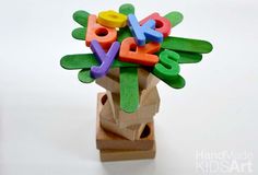 a wooden toy with letters on top of it that spell out the word yes in different colors