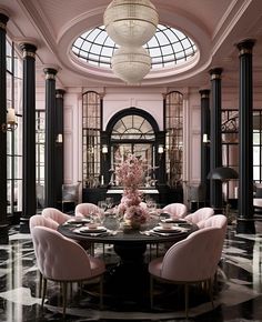 a dining room with black and white marble flooring, chandelier and pink chairs