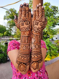 a woman's hands with henna tattoos on her hand and the words wow written in arabic