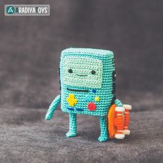 a small crocheted toy with toothbrushes and toothpaste in it