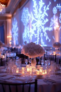 the centerpieces are lit up with candles and flowers