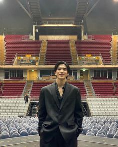 a man standing in front of an empty auditorium