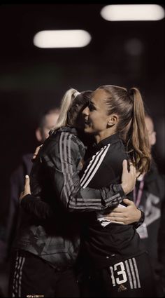 two female soccer players hugging each other