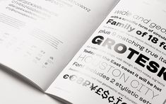 an open book with black and white typograms on the pages that read grotek