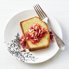 a piece of bread with toppings on it sitting on a plate next to a fork