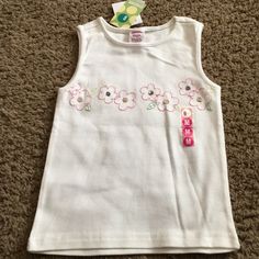 Nwts Vintage Gymboree White Top Has Embroidered Flowers With Sequin Accents In Center Of Each And It Is From The Leapin Lily Pads Lune. Sz Medium (Age 4). Imo This Top Could Easily Go With The Butterflies Shirts I Have Listed. If You Would Like To Purchase Multiple Items Be Sure To Click The Bundle Link In Each Listing And Pay Only One Shipping Fee As Long As Total Weight For All Items Is Under 5 Pounds Smoke-Free Home. Cute White Sleeveless T-shirt, Cheap T-shirt With Floral Applique, Vintage Mickey Mouse Cotton Top, Gymboree Play And Music, Vintage Gymboree, Butterfly Shirts, Embroidered Flowers, Vintage Baby, Lily Pads