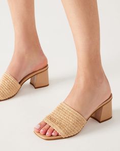 CLEAN + CHIC + SUNNY An easy slide with a comfortable square toe and block heel, the RAIA sandal features a wide woven raffia strap for a textured finish. Square toe block heel slide sandal Slip-on style Wide woven raffia strap Angled block heel 2.75 inch heel height Synthetic upper material Vegan leather lining Synthetic sole Imported Summer Mules With Wooden Block Heel, Summer Beach Heels With Square Toe, Casual Summer Block Heels With Stacked Heel, Casual Block Heels With Stacked Heel For Summer, Natural Sandals With Stacked Heel For Vacation, Summer Beach Block Heels With Padded Heel, Square Toe Beige Sandals For Summer, Woven Mules For Summer, Summer Mules With Wooden Heel