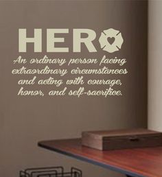 there is a wall decal that says hero on the side of a table in a room