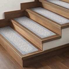 a set of wooden stairs with carpeted treads