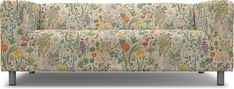 an upholstered couch with colorful flowers and plants on the back, against a white background