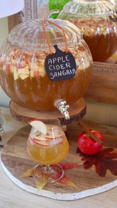 apples cider sangma is sitting on a table with other drinks in front of it