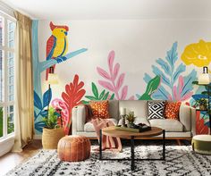 a living room decorated with colorful tropical wallpaper and art work on the walls, along with an area rug