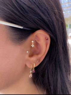 a close up of a person wearing some kind of ear piercing with other items in the background