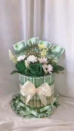 a birthday cake made out of money and flowers