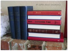 a stack of books sitting on top of a brick wall