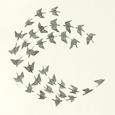 a flock of birds flying across a white sky in the shape of a sunburst