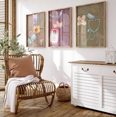 a room with three framed pictures on the wall and a wicker chair next to it